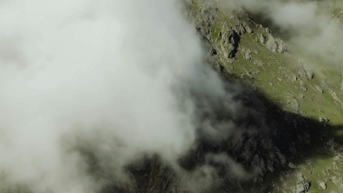 Fog rolling over green mountains